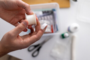 concept of first aid for cuts and injuries. knife cut in the kitchen, wound treatment and dressing