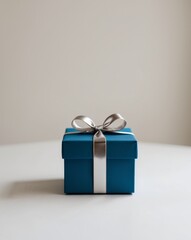 A blue gift box with a silver bow on top.
