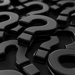 Close-up of glossy black question marks scattered on a dark surface, creating a sense of mystery and inquiry.