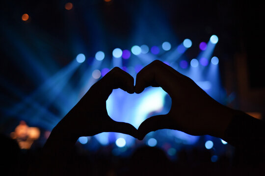 Heart-shaped hand at concert