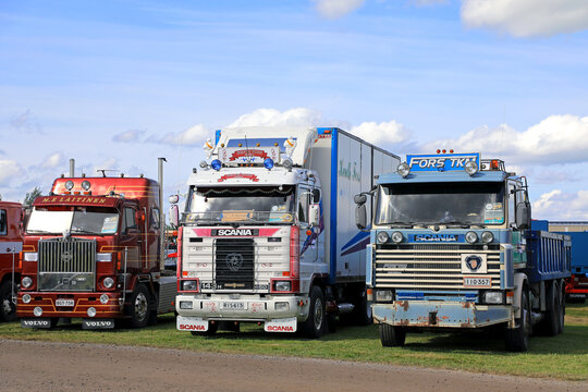 Classic, customized Scania 143 H and 142 and Volvo 88 Cab-Over Heavy Trucks Parked in a Row.