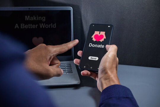 Man holding a smartphone to make an online donation. Online donation, volunteer and charity concept.