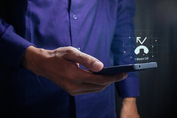 Man using a mobile phone with with missed call notification on the virtual screen