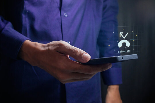 Man using a mobile phone with with missed call notification on the virtual screen