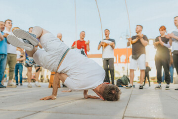Man dancing capoeira, hanging out, fighting