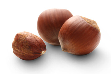 Whole and cracked hazelnuts isolated on white