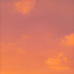 A bright and beautiful orange sky, with clouds at dawn, creates a heavenly backdrop for the sunrise.