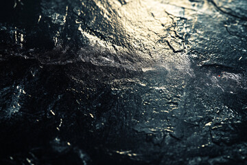 Obraz premium a textured dark surface is softly illuminated by golden light creating abstract patterns of depth and subtle brilliance 