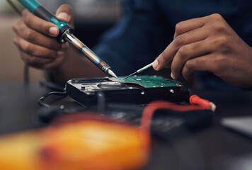 Circuit board, engineering and soldering iron with hands of person in office for maintenance or repair. Business, hardware and technology with IT technician fixing mobo connection in workshop closeup