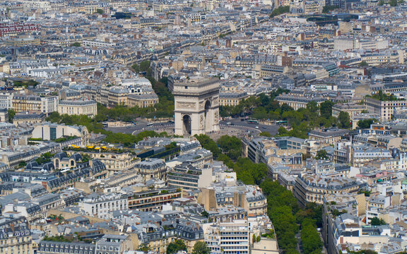 A stunning stock photo capturing a bird's eye view of a charming Parisian neighborhood from the top of the Eiffel Tower. The image highlights the intricate layout of streets and the Arc de Triomphe.