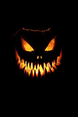 Fototapeta premium Halloween pumpkin with fangs on black background