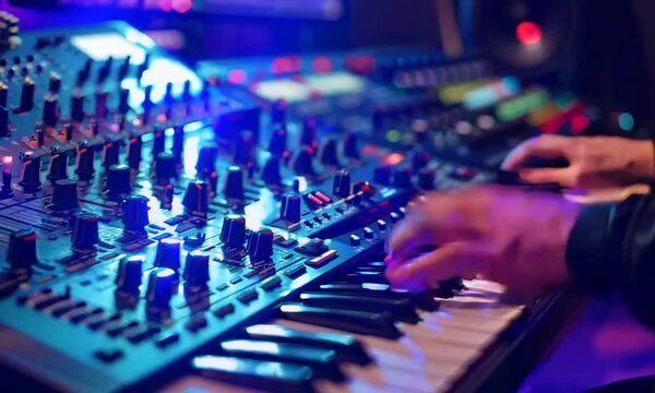 DJ artist mixing music with studio equipment and record keys in action