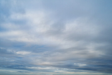 white fluffy clouds standing out against  a blue sky