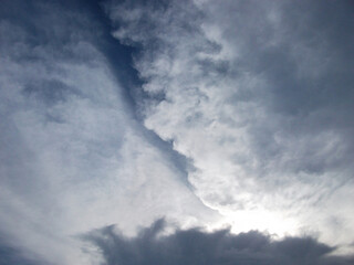 Blobs of white clouds on a cloudy background