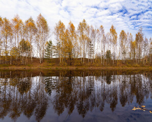 Fototapeta premium autumn landscape with river, road and clouds in the blue sky