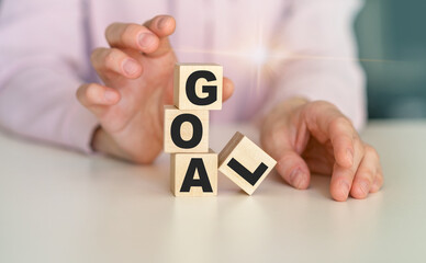 GOAL word written on wood block. goal text on table, concept.