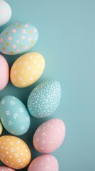 Obraz premium Decoratively colored Easter eggs arranged on a light blue wooden surface in springtime