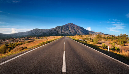 long empty road with a mountain in the background