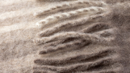 Alpaca wool mix soft warm scarf, pattern background. Trendy cream beige color wool texture