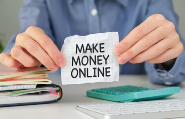 Fototapeta premium MAKE MONEY ONLINE, message on the card shown y a businesswoman