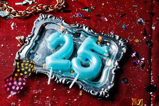 lit birthday candles forming number 25