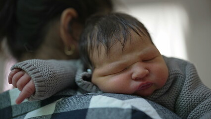 Mother tenderly holding her newborn baby on her shoulder in a peaceful, sunlit room. The baby sleeps soundly, illustrating the deep love and gentle care shared between mother and child