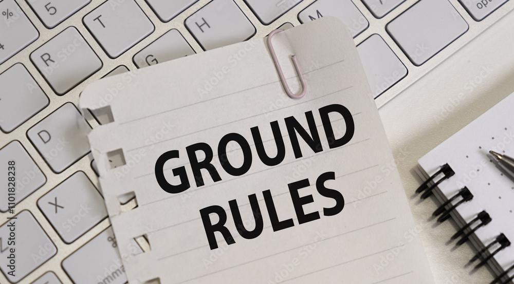 Poster notebook with text ground rules and pen on wooden table, top view