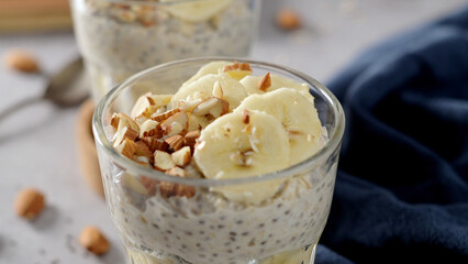 Two bowls of overnight oats topped with banana slices and almonds