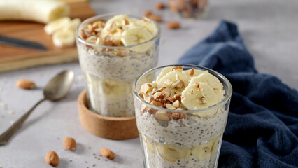 Two bowls of overnight oats topped with banana slices and almonds