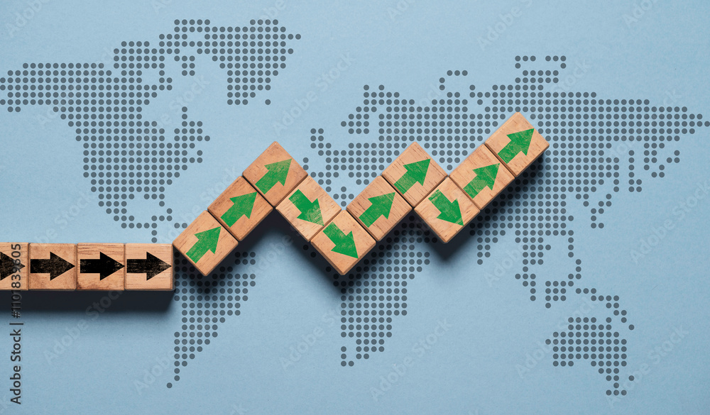 Poster green up arrow print screen on wooden block cube with world map for global economic growth concept.