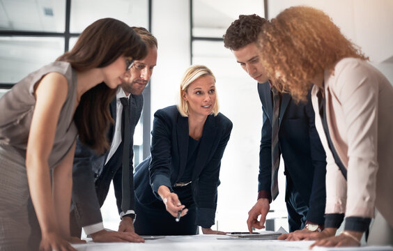 Architecture, meeting and business people in office with documents for planning, building design and floorplan. Construction, professional and men and women with floorplan for discussion and teamwork