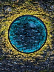 Circle of colour on stone wall