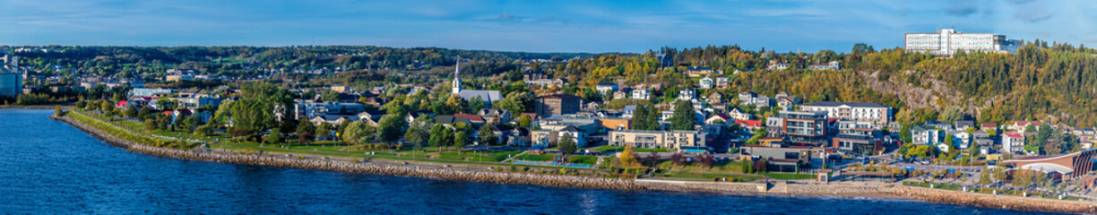 Fototapeta premium A panorama view along the shoreline from the cruise terminal in the bay at Saguenay, Quebec in Canada in the fall