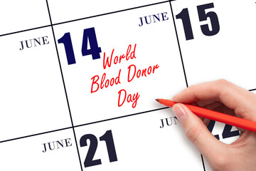 June 14. Hand writing text World Blood Donor Day on calendar date. Save the date.
