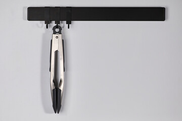 Fototapeta premium Pasta tongs hanging on a magnetic stand in the kitchen