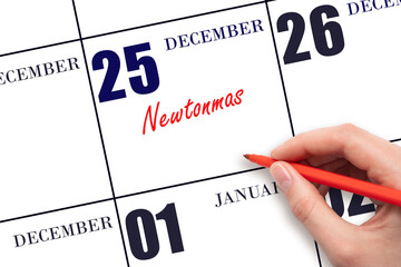 December 25. Hand writing text Newtonmas on calendar date. Save the date.