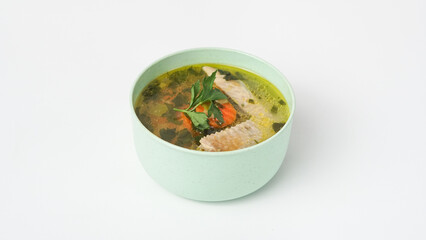 Homemade chicken soup in a bowl on a white background