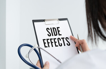 Doctor holding a card with text side effects. Medical and healthcare concept