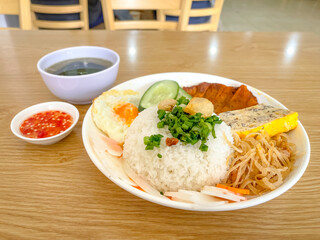 Vietnamese grilled rib broken rice, shredded pork skins, fried egg and meat patty served with fish-sauce. Flat pork ribs marinated with spices, glazed with liquid caramel, then charcoal-grilled.