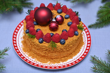 beautiful and appetizing Christmas cake on the table and fir branches