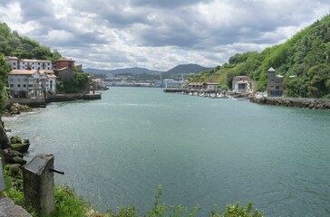 Views of the Cantabrian Sea towards the fishing port of Pasaia on a bright and sunny day.