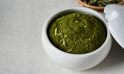 closeup Brazilian green yerba mate or Brazil Chimarrao food in ceramic bowl on white table background with copy space