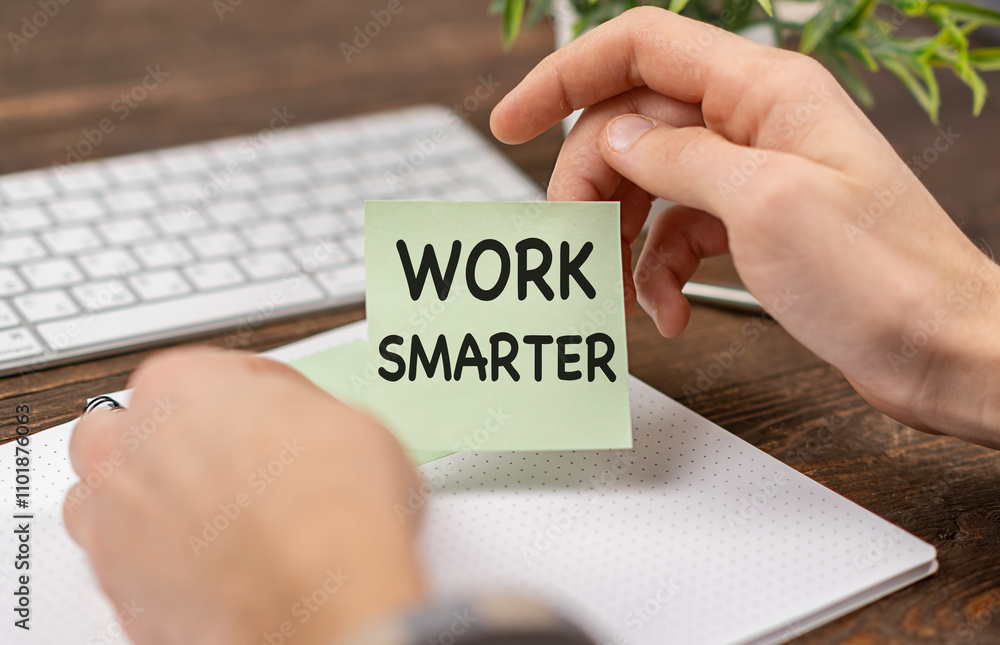 Poster work smarter text on paper in hand with pen and keyboard on a wooden background