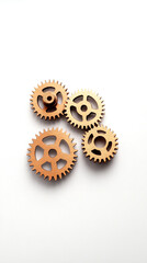 Four wooden gears arranged aesthetically on a light background, showcasing intricate designs and mechanical beauty.