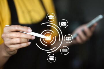 A person is holding a stylus and pointing at a screen with a circle