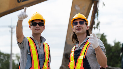 Caucasian white civil engineer, architect, or construction worker is wearing a safety suit while inspecting building construction on site and verifying blueprints or drawing plans.