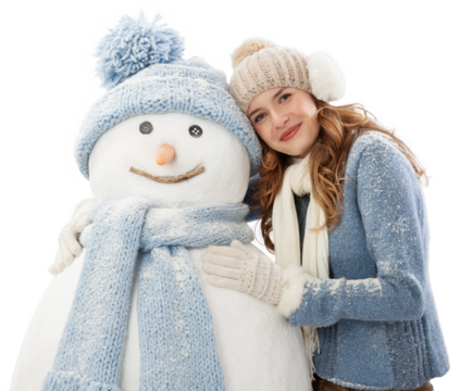 Happy young woman enjoying embracing a snowman dressed in warm winter clothing, hat and scarf knitted. Ski trip during the Christmas holidays in winter season. Cooling and Heating temperatures concept