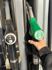 A person is filling up their car with gas at a gas station