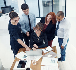 Business people, team and discussion by laptop, documents and point for solution with charts in...