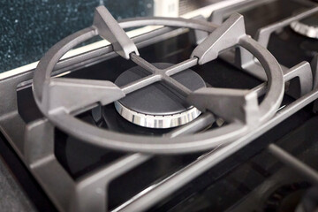 Gas stove burner burning without flame. Modern gas stove for cooking. Close up cast iron gas...